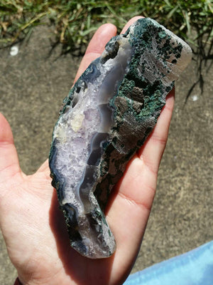 Amethyst geode slab - caoxinite inclusions - on stand