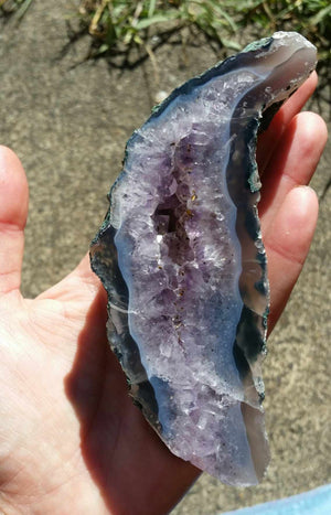 Amethyst geode slab - caoxinite inclusions - on stand