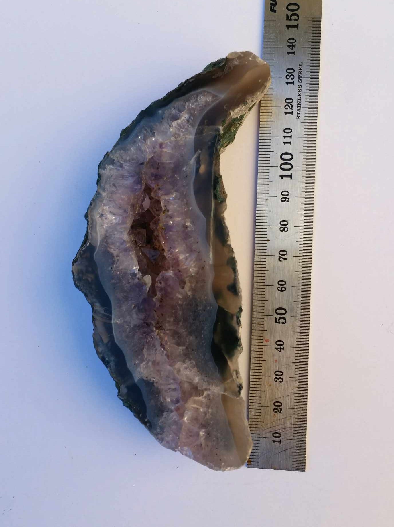 Amethyst geode slab - caoxinite inclusions - on stand